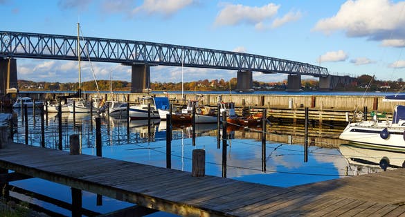 photo of view of Old Little Belt Bridge and small town of Middelfart Denmark Scandinavia travel destination.