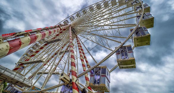 photo of view of Honfleur, France - A low angle view of a Ferris wheel (Grande roue de Honfleur) against a cloudy sky.
