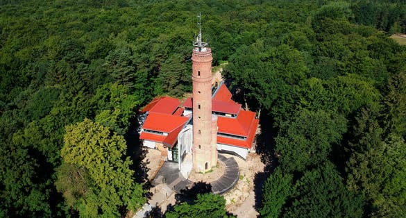 Observation and telecommunications tower in the forest, aerial view .