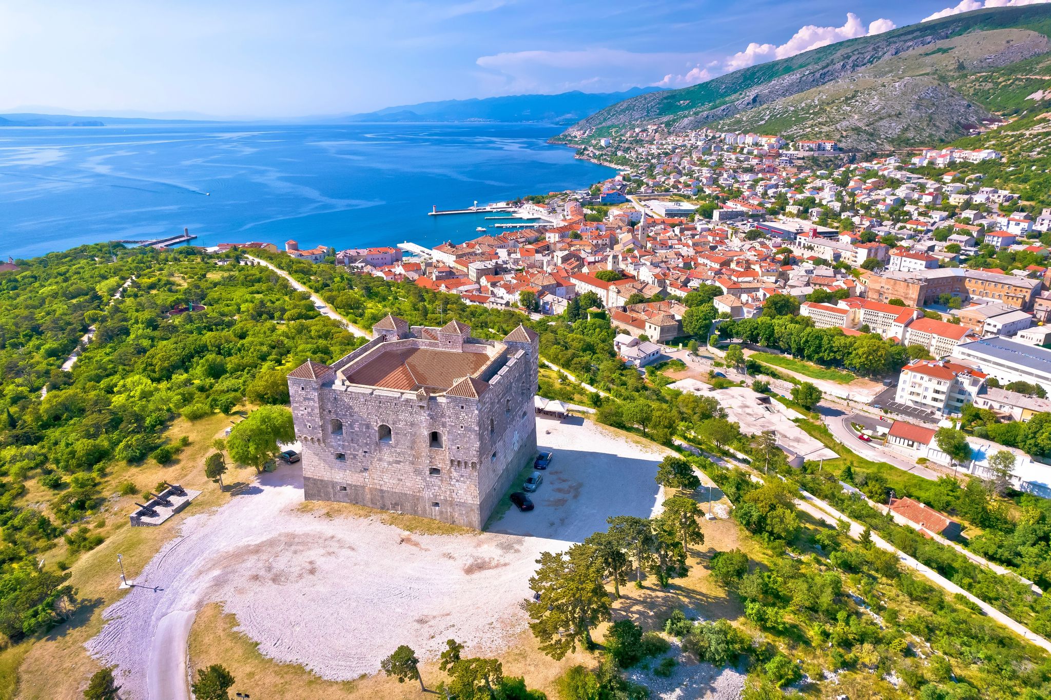 Photo of aerial view of Nehaj fortres in Senj on green hill, Primorje region of Croatia.