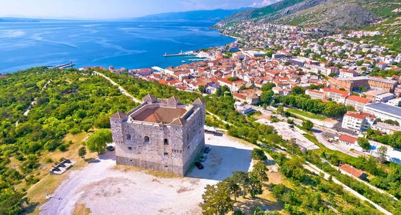 Photo of aerial view of Nehaj fortres in Senj on green hill, Primorje region of Croatia.
