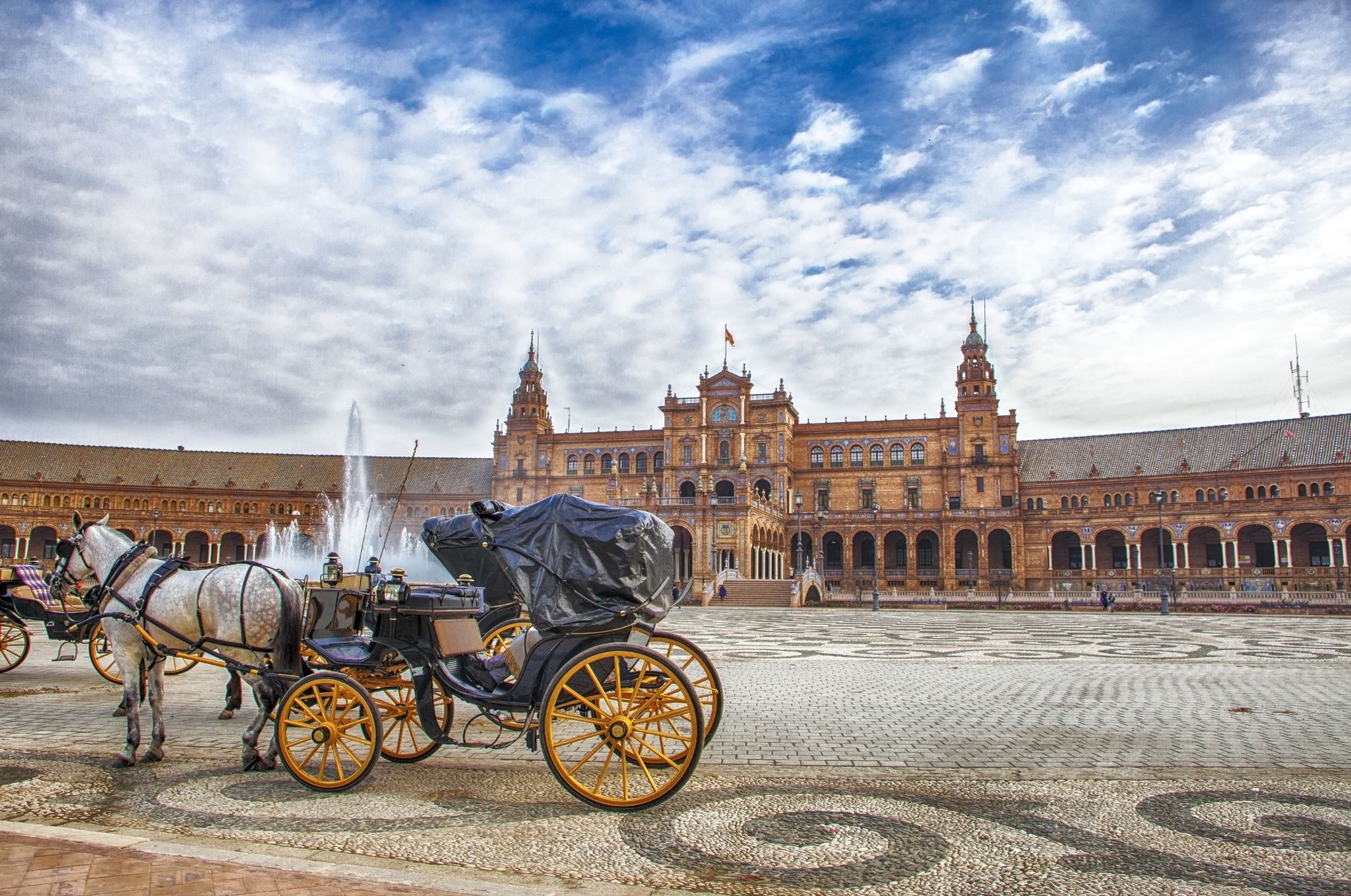 Parked Horse drawn carriages at Plaza de Espana in Seville.jpg