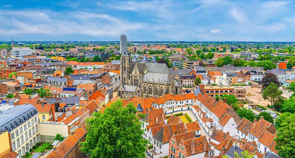 Aerial panoramic view of Kortrijk historical city centre with Roman Catholic Church of Our Lady, Courtrai Begijnhof and red tiled roof buildings, horizon amazing view, West Flanders province, Belgium