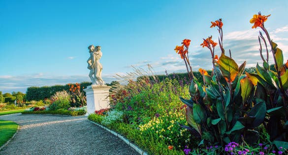 Photo of Beauty of nature of Herrenhausen gardens (baroque style) of Hannover with statue and flowerbeds.
