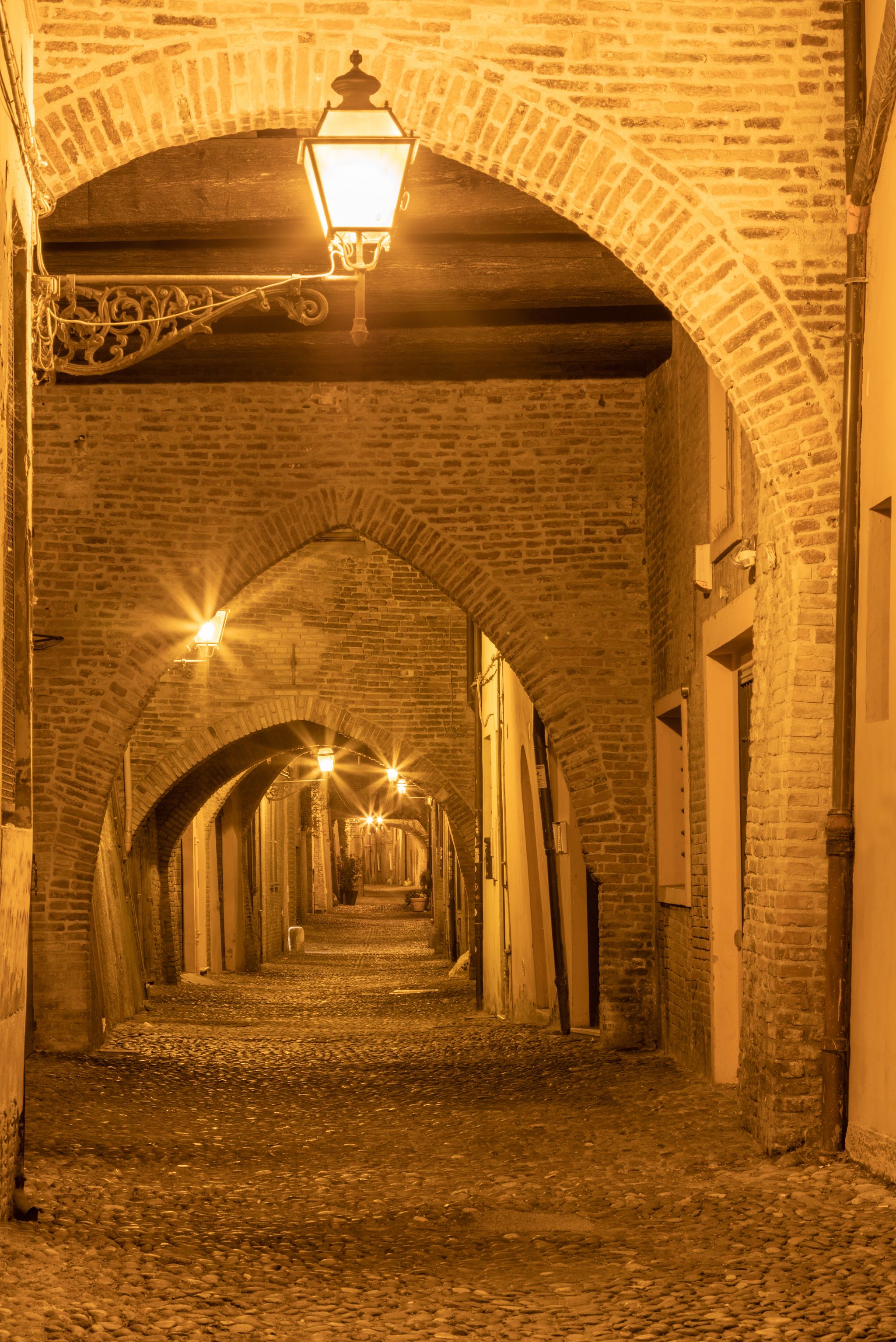Ferrara - The street Via delle Volte - old merchantns street in the old town at dusk.