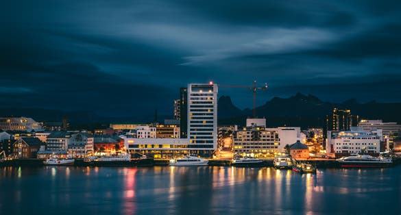photo of view of A long exposure photograph of Bodø city at night with dramatic clouds