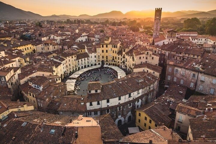 Aerial view of Piazza dell-Anfiteatro in Lucca, Italy, at sunset with warm light over historic rooftops..jpg