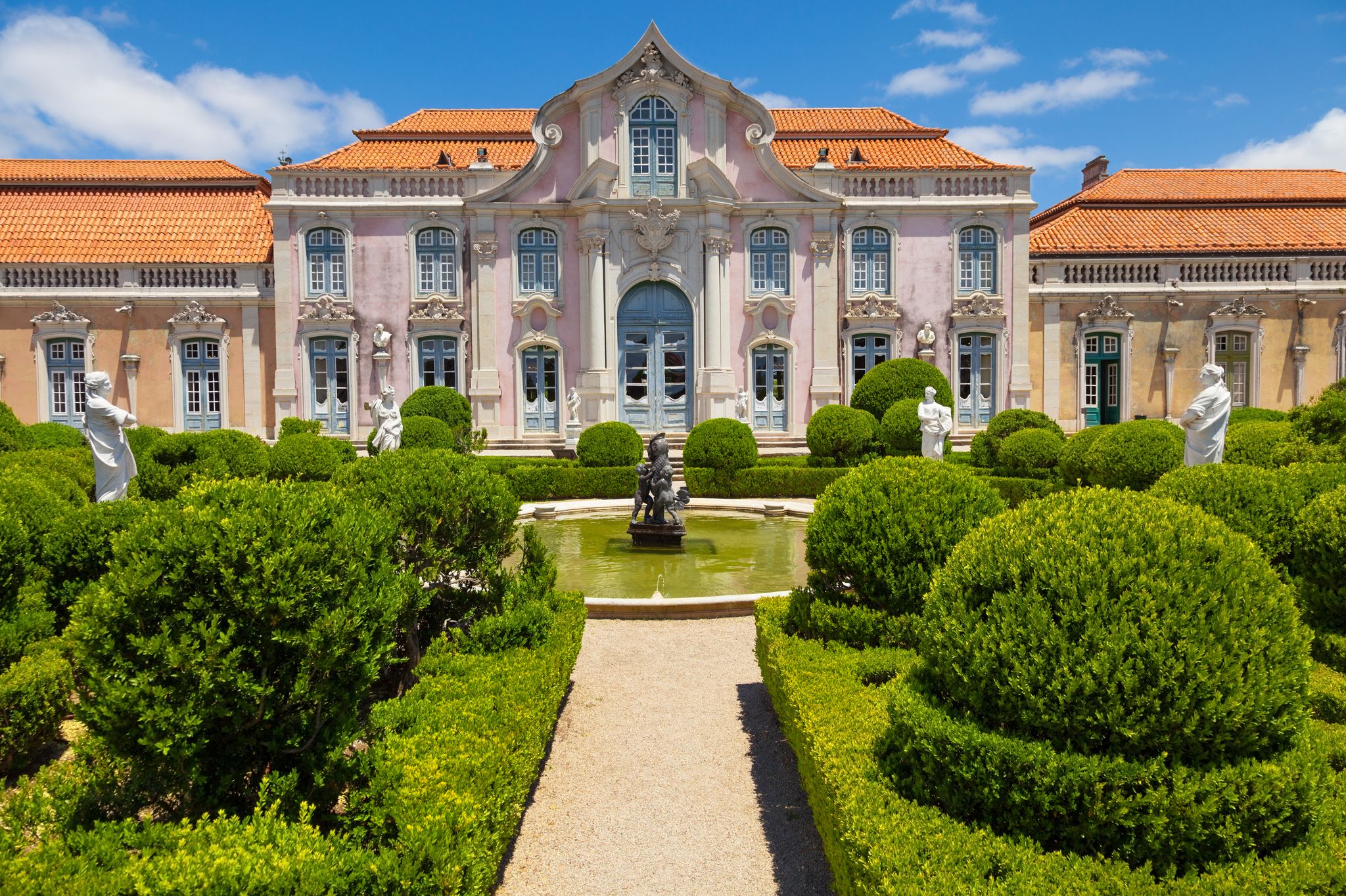 Photo of Baroque facade of Queluz National Palace and Neptune Fountain in Sintra, Lisbon district, Portugal.
