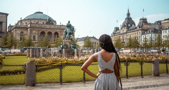 Photo of girl in beautiful old royal square in Copenhagen Denmark, Kongens Nytorv Square, Denmark.