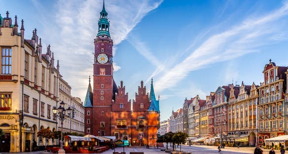 Photo of colorful evening scene on Wroclaw Market Square with Town Hall. Sunset in historical capital of Silesia, Poland.