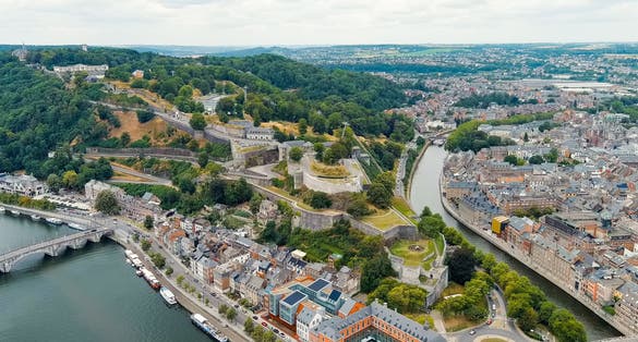 photo of view of Namur, Belgium. Citadelle de Namur - 10th-century fortress with a park, rebuilt several times. Panorama of the central part of the city. River Meuse. Summer day, Aerial View