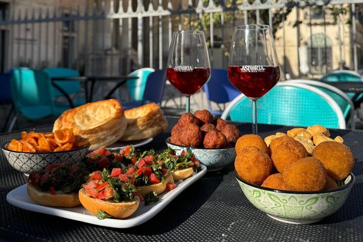 Traditional aperitivo with local snacks and red wine on a sunny terrace in Lecce, Southern Italy..jpg