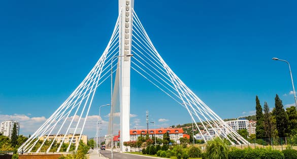 Photo of wonderful white Millennium bridge structure over clear blue sky in Podgorica, Montenegro.
