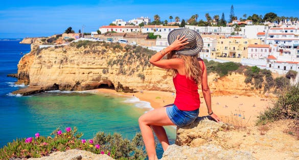 Photo of woman tourist in Faro beautiful beach and village, Portugal.