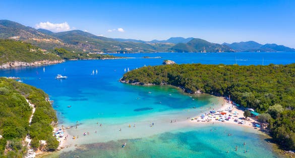 Photo of aerial view of iconic paradise sandy beaches with turquoise sea in complex islands of Agios Nikolaos, Greece.