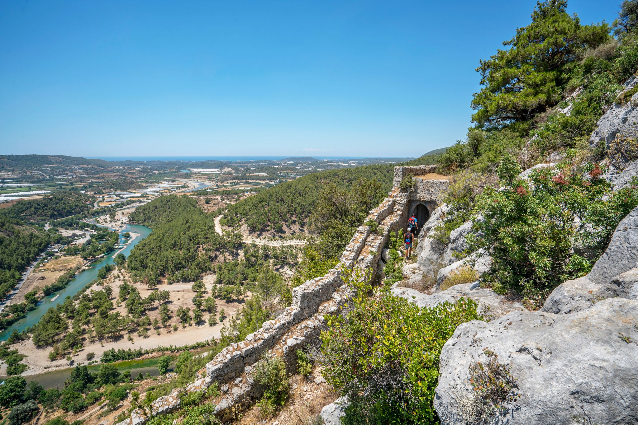 photo of panoramic view of Alara river and Alara Castle, which had the function to safeguard the caravans from holdup robberies that were stopping over at the last caravanserai Alarahan on the Silk Road in Antalya, Turkey.