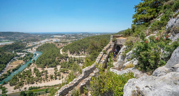 photo of panoramic view of Alara river and Alara Castle, which had the function to safeguard the caravans from holdup robberies that were stopping over at the last caravanserai Alarahan on the Silk Road in Antalya, Turkey.