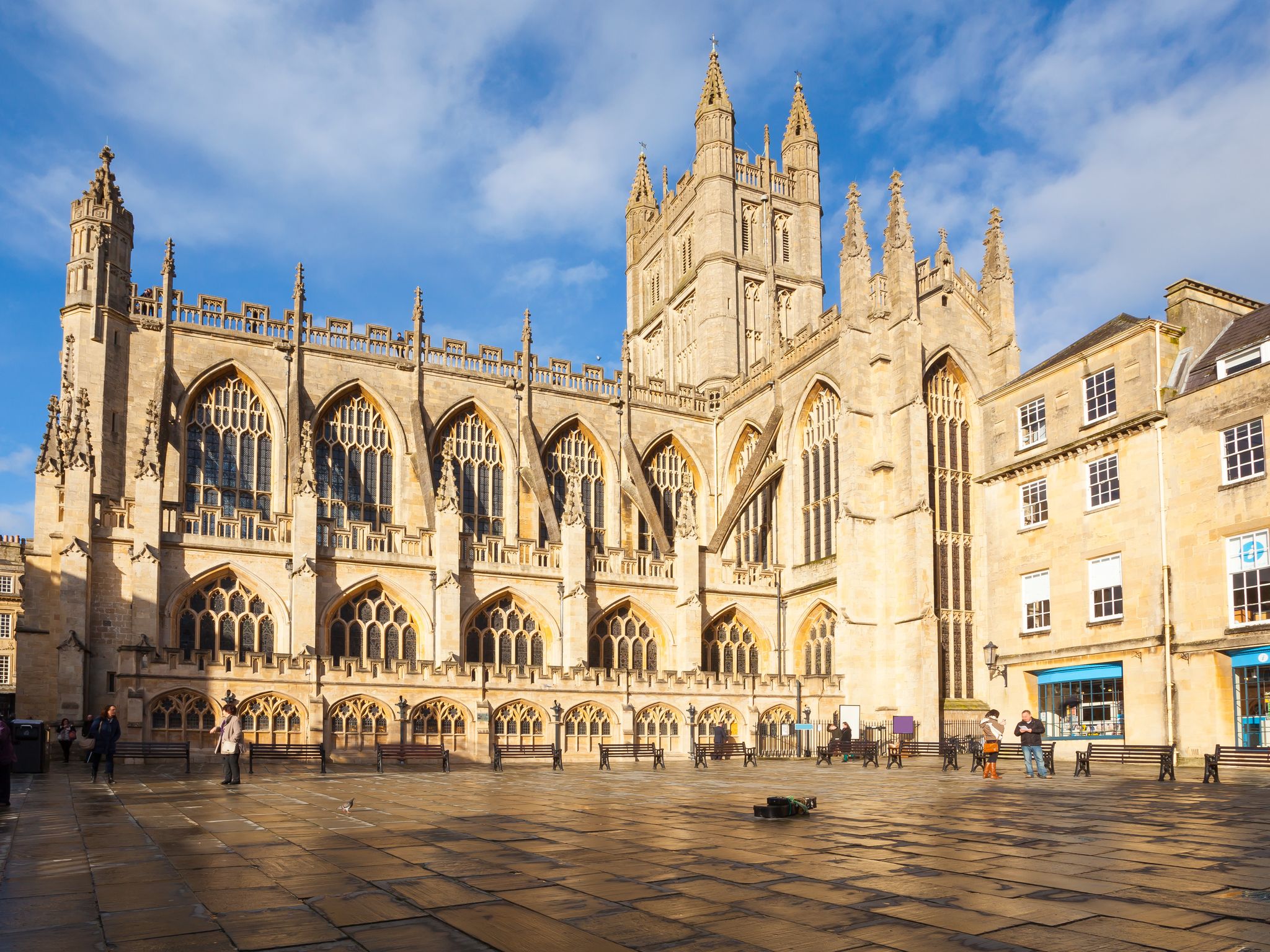 Photo of historic Bath Abbey and roman baths building in Bath Old town center, England.