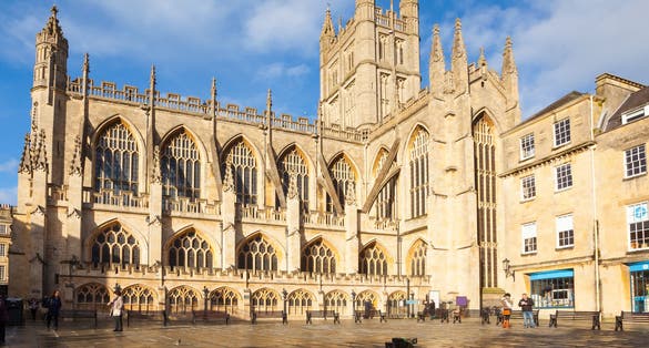Photo of historic Bath Abbey and roman baths building in Bath Old town center, England.