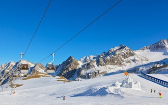 Photo of a view of the Alps from the Ehrwald, a town on the border of Germany and Austria with picturesque meadows surrounded by towering mountain ranges, including the Zugspitze.