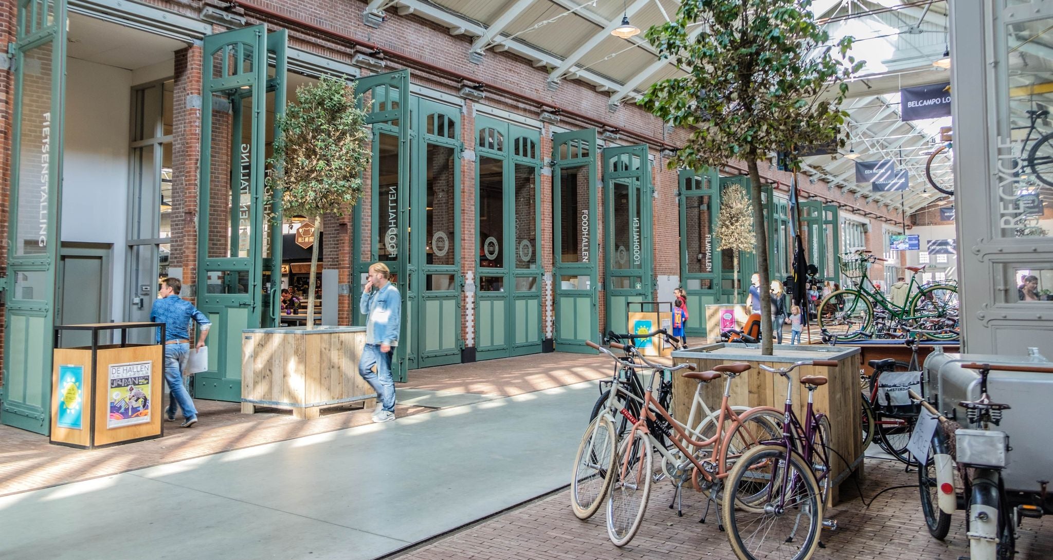 People walking and cycling near the entrance of De Hallen food market in Amsterdam..jpg