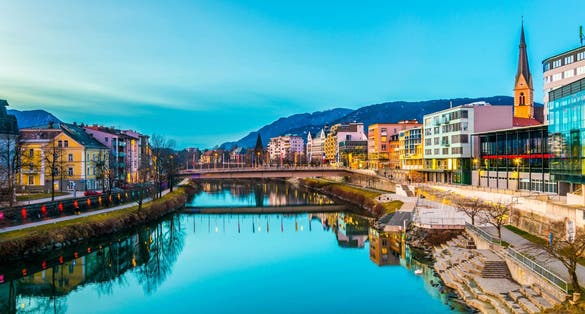 view of a riverside of river Drau during sunset in Villach, Austria