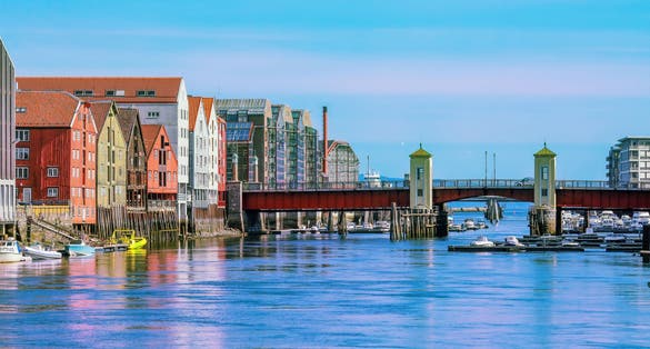 The view of the bridge Bakke Bru, the river Nidelva and historical old timber buildings in Trondheim, Norway.