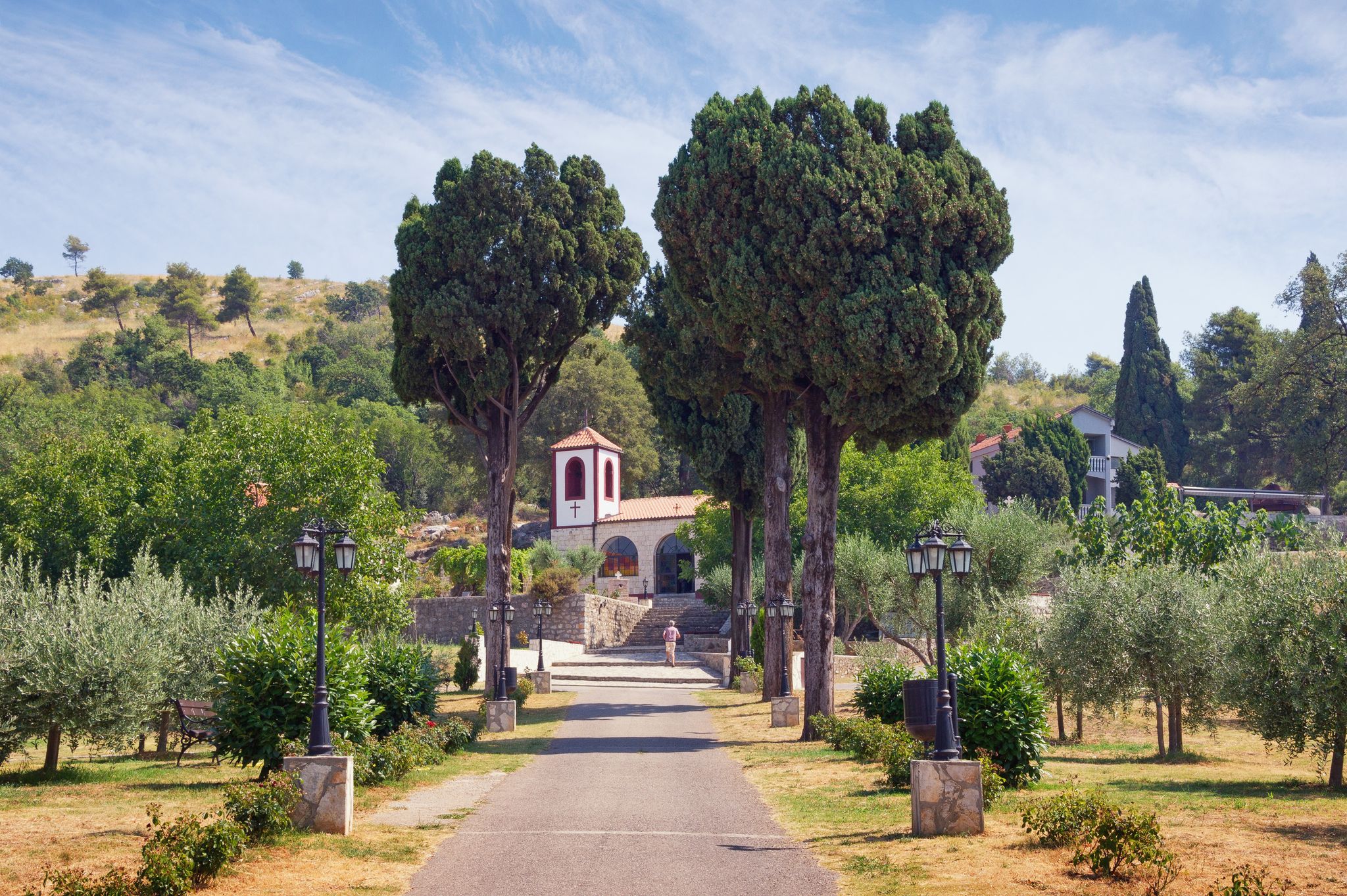 Photo of road to the temple. View of Serb Orthodox Christian Monastery of Dajbabe, the church is located in the cave, Podgorica, Montenegro.