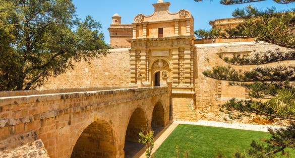Photo of entrance bridge and gate to Mdina, a fortified medieval city in the Northern Region of Malta.