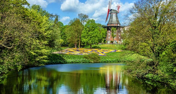 Mill in green park and lake, Bremen, Germany