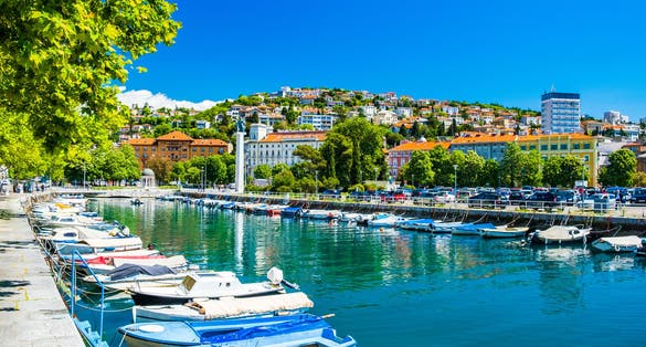 Photo of city of Rijeka, skyline view from Delta and Rjecina river over the boats in front, colorful old buildings, Croatia.