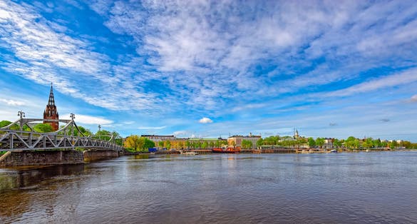 Porin silta the Pori Bridge (1926) crossing Kokemanjoki river and Neogothic style Central Lutheran Churchin in Pori, Finland