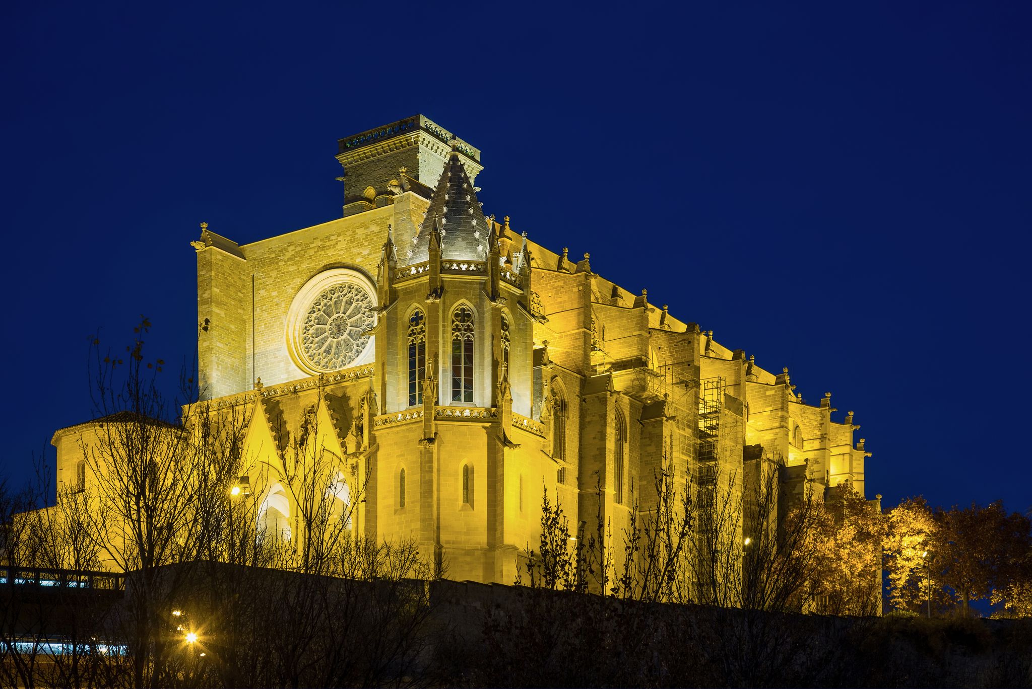 Photo of Basilica of Santa Maria de la Seu with evening lights in Manresa, Spain.