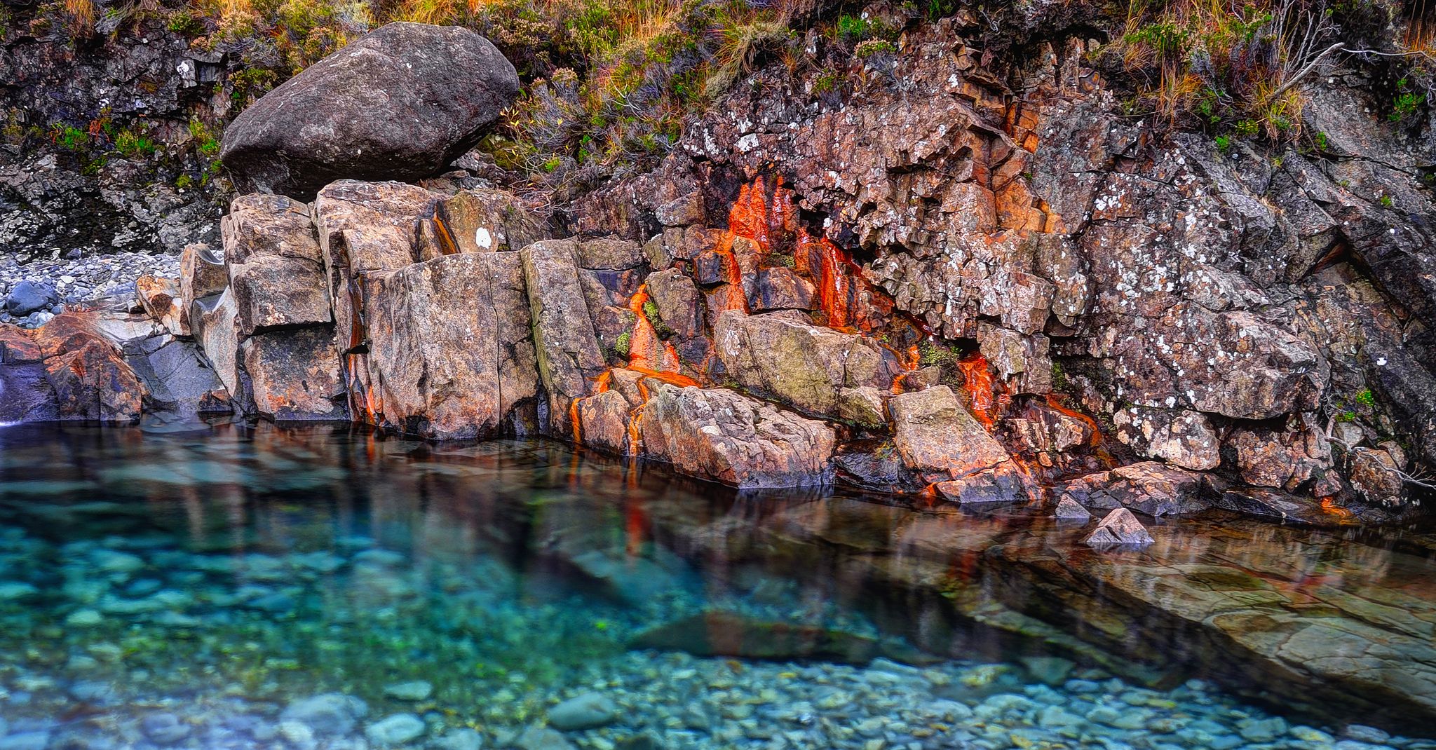 Photo of Rusted rocks in Fairy Pools, Glen Brittle, Isle of Skye, Inner Hebrides, Highlands, Scotland .