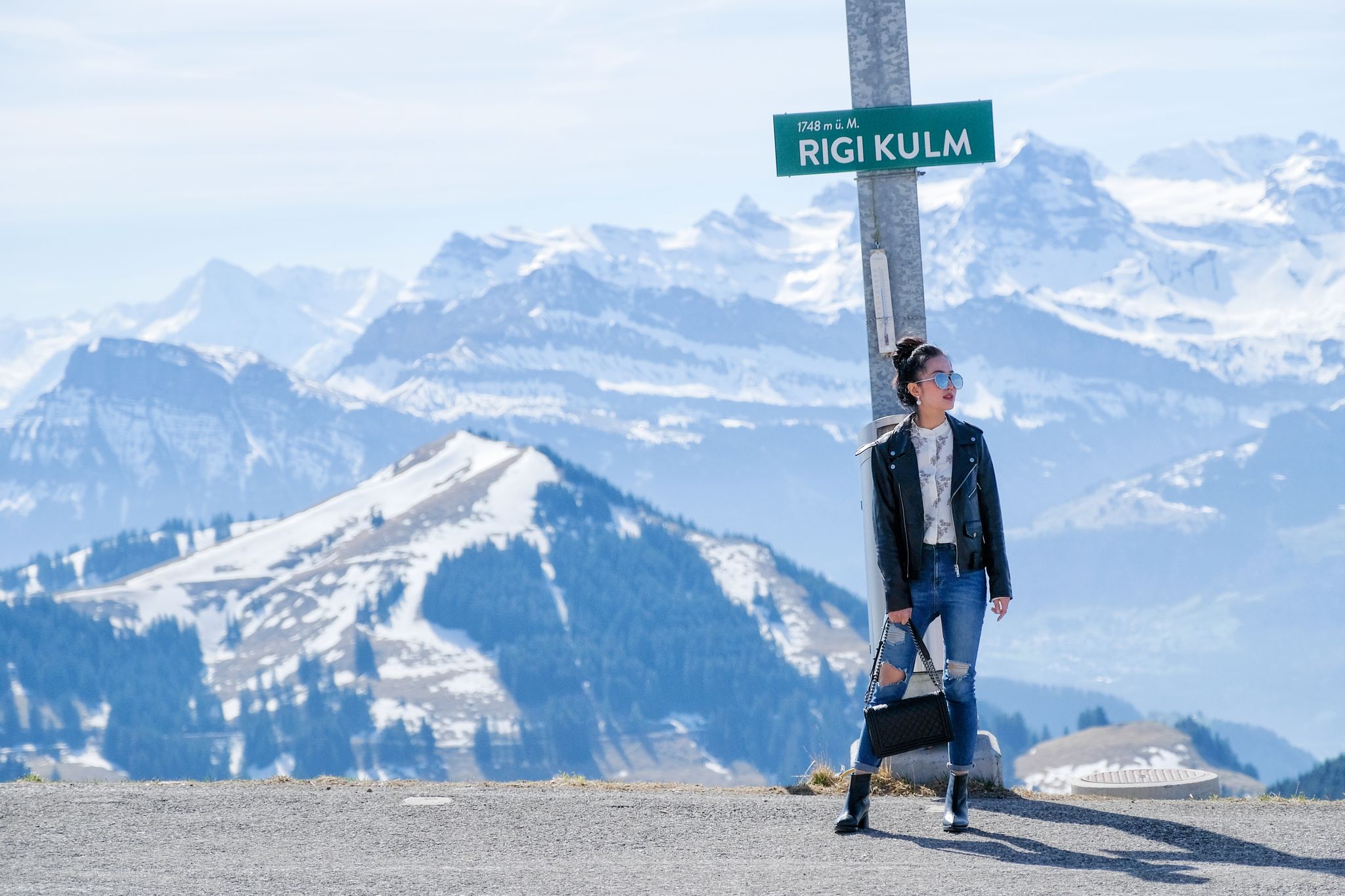 photo of young woman on Rigi mountain in Switzerland with a magnificent panoramic view of Swiss alps.