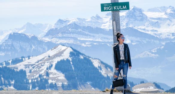 photo of young woman on Rigi mountain in Switzerland with a magnificent panoramic view of Swiss alps.