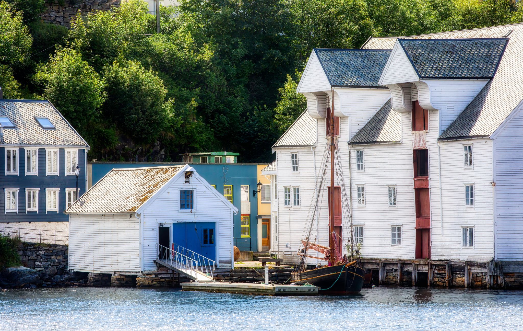 Old Wooden Buildings and Vessel on the Shore at Alesund in More og Romsdal, Norway