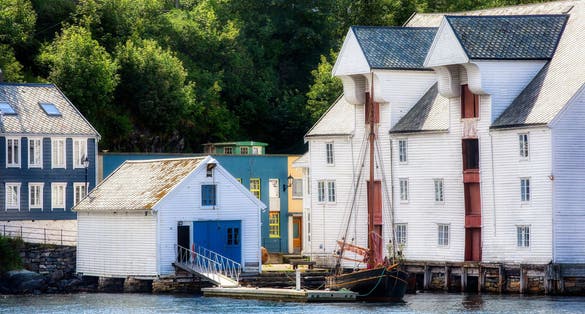 Old Wooden Buildings and Vessel on the Shore at Alesund in More og Romsdal, Norway