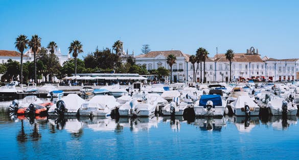 Photo of boats at the marina of Faro with clear blue sky Algarve, Portugal.
