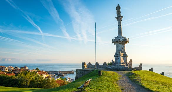 Photo of Comillas marquis monument facing the Cantabric sea and blue sky. province of Santander, Spain.