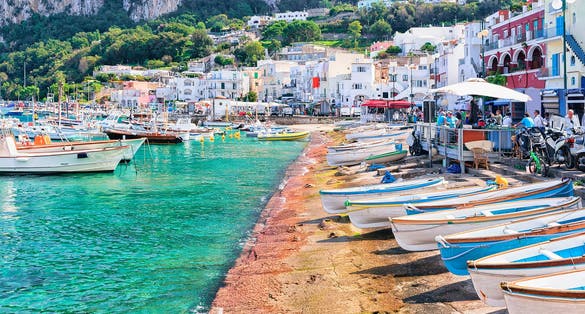 Photo of Boats at Marina Grande embankment in Capri Island in Tyrrhenian sea, Italy.