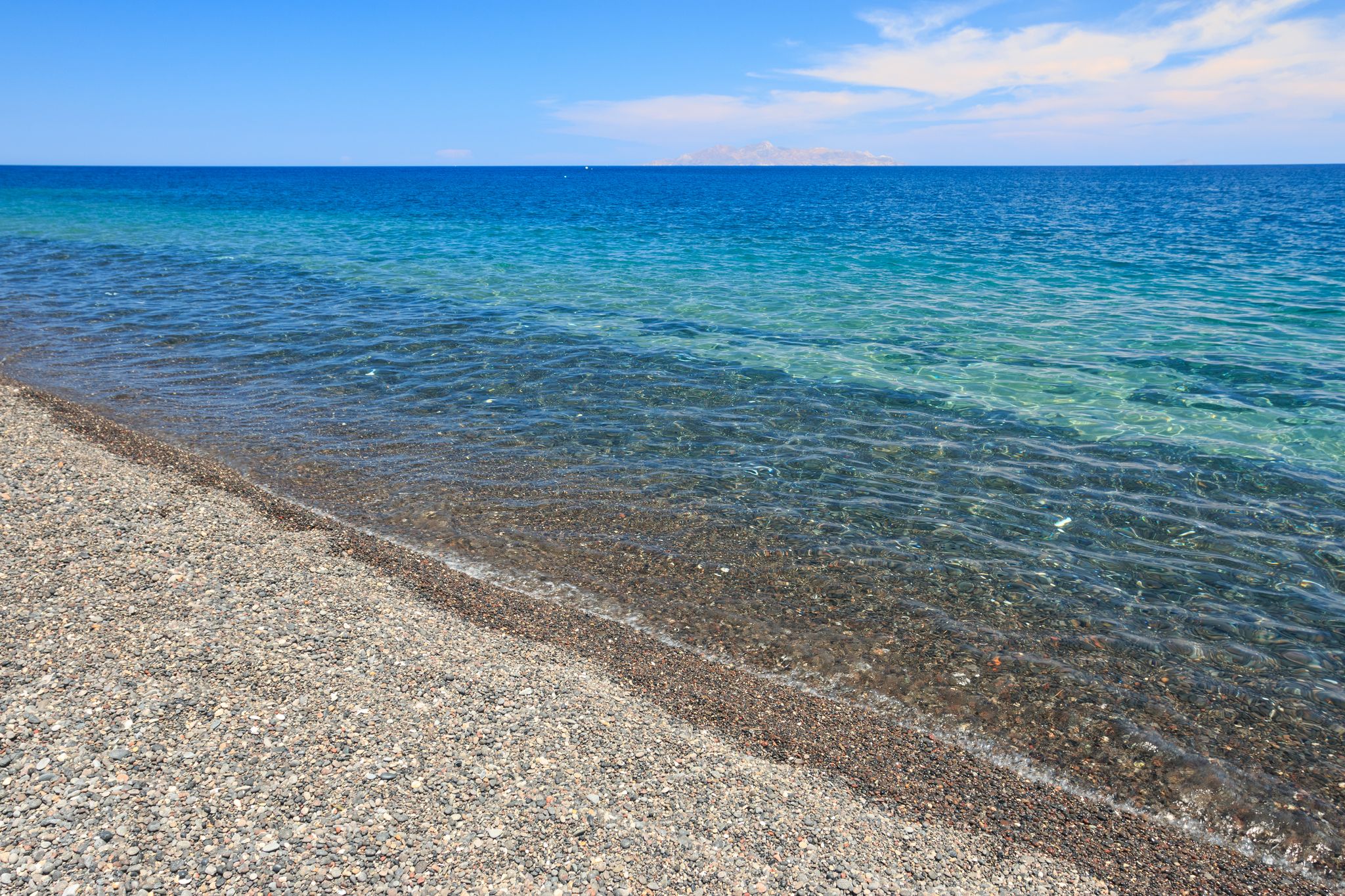 Photo of scenic aerial view of Kamari village and beach at sunrise, Greece.