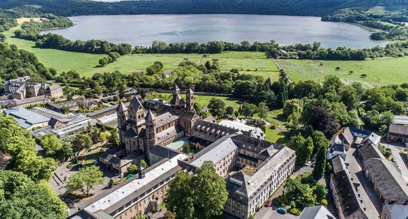 photo of view of Aerial view on Laacher See behind the famous abbey Maria Laach in Rhineland-Palatinate, Germany.