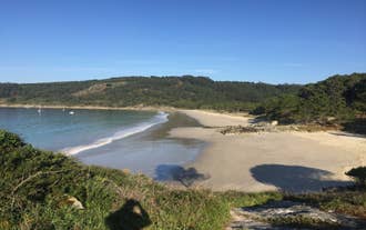 Photo of aerial view of an empty beach in Portonovo in the Ria de Pontevedra, Spain.