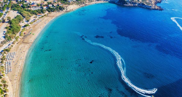 Photo of aerial panoramic beautiful view of Coral bay beach with jet ski and people having fun, Cyprus.