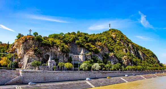 Photo of Liberty Statue and the Cave Church on the Gellert Hill in Budapest, Hungary.