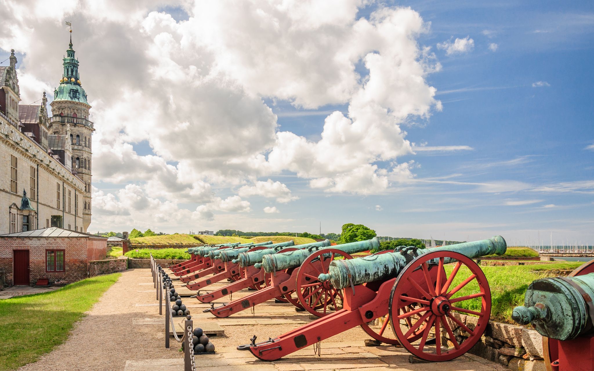 Photo of several old cannons at the walls of Kronborg castle. They guarded the entrance to an ancient sea Fort, Helsingor, Denmark.