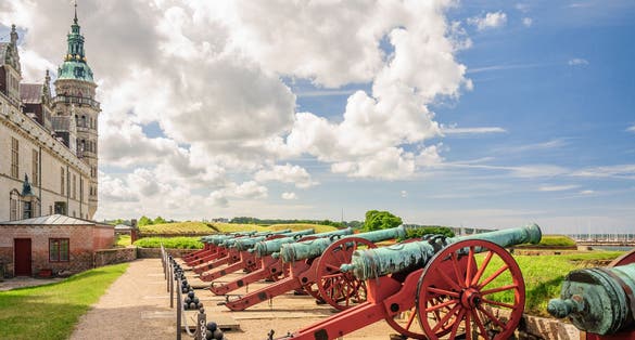 Photo of several old cannons at the walls of Kronborg castle. They guarded the entrance to an ancient sea Fort, Helsingor, Denmark.