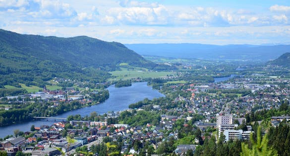 Beautiful landscape of the Drammen city with river and the mountains in Norway. Blue sky background.