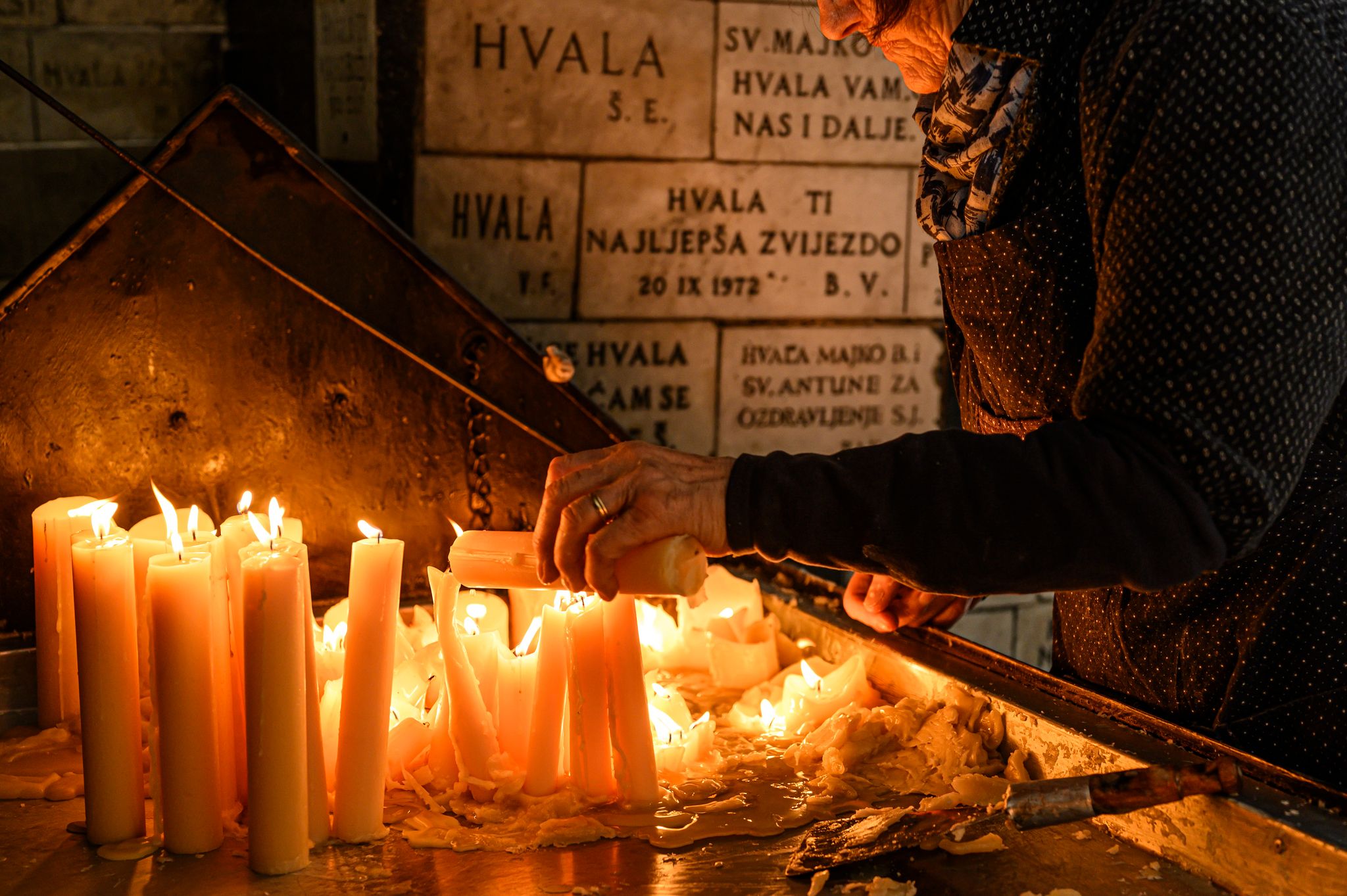 Photo of Lighting candles in Kamenita vrata (Stone Gate) to remember and honor the deceased loved ones.